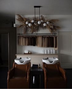 two white sinks sitting next to each other on top of a wooden table in front of a window