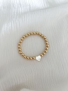 Mother of pearl heart on your choice of our 4mm or 6mm gold ball bracelet 14k gold filled Breclate Aesthetic, Everyday Jewelry With Heart Charm And Round Beads, Gold Bracelet With Pearl Charm, 14k Gold Filled, Dainty Jewelry With Heart Charm And Round Beads, Hypoallergenic 14k Gold Beaded Bracelets With Round Beads, Hypoallergenic 14k Gold Beaded Bracelets, Dainty Bracelet With Heart Charm And Round Beads, Dainty Heart Charm Bracelet With Round Beads, Dainty Jewelry With Heart Shaped Round Beads