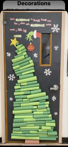 a christmas tree made out of rolled up paper on the front door to decorate it