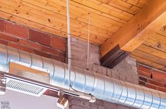 a ceiling mounted exhaust system in a brick building