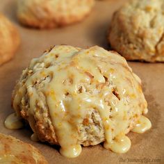 biscuits covered in cheese sitting on top of a baking sheet