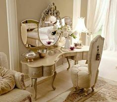 a dressing table with chairs and a mirror