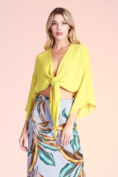 This sexy top is perfect for a night out, date night, vacation wear or after-hours. Pair with shorts, skirts, jeans, pants and with swimwear. Wear with pasties, bralettes, tank tops, bikinis or alone. The self-tie closure gives you freedom to secure the top in the front, side or back, depending on your liking. Deep v neckline 3/4 Sleeves Kimono-style body Tie-front closure Crinkle chiffon-like fabric 100% Polyester Made in USA Devin is 5'8" and is wearing a size small. SKU #: T-6873 Chic V-neck Top For Beach Season, Trendy Triangle Top For Party, Summer V-neck Crop Top For Brunch, Chic Triangle Top For Beach, Chic Triangle Top For The Beach, Trendy V-neck Crop Top For Beach, Summer V-neck Blouse For Night Out, Spring Triangle Crop Top For Night Out, Spring Vacation V-neck Crop Top