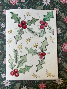 a christmas card with holly and berries on it