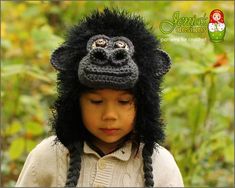 a young child wearing a crocheted gorilla hat