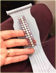 a person is holding a guitar string in their hand and it's strings are being sewn together