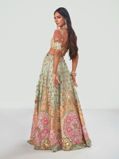 Editor's Note Featuring a stunning Sangeet look with a bejeweled tone as styled by Ami Patel in South Asian Bride 101. A teal green tulle lehenga embroidered with custom cut acrylic pieces, gold metal embellishments and appliqué of rich fabric. It is paired with a teal green embroidered bralette and delicate tulle pre-draped dupatta with tasseled gold metal embellishments. Color: Teal green Fabric: Tulle Neckline: Sweetheart Sleeve type: Half Embroidery details: Acrylic pieces, gold metal embell Customized Lehenga Designs, Bridal Sangeet Lehenga, Unique Mehendi Outfits For Bride, Sangeet Outfit Bridal, Teal Lehenga, Punjabi Clothes, Mehendi Outfits For Bride, Sangeet Look, Tulle Lehenga