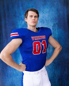 a man in a football uniform is posing for a photo with his hands on his hips