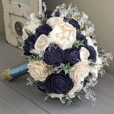 a bridal bouquet with white and blue flowers