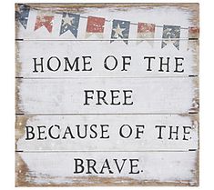 a wooden sign that says home of the free because of the brave with bunting flags