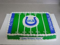 a birthday cake that is shaped like a football field with the colts logo on it