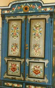 a blue cabinet with pictures on it and the words mobla picta la comunada painted furniture / pinter