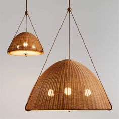 two hanging lights made out of wicker with one light turned on and the other down