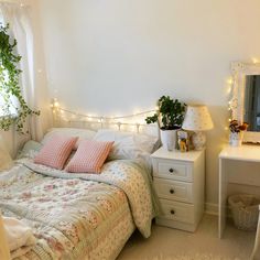 a bedroom with white furniture and lights on the wall above the bed is decorated in pastel colors