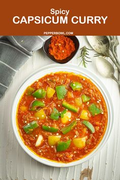 a white bowl filled with soup next to spoons