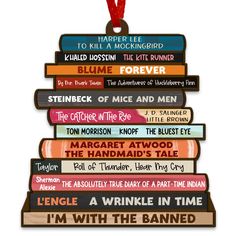 a stack of books hanging from a red ribbon on top of a wooden sign that says i'm with the band