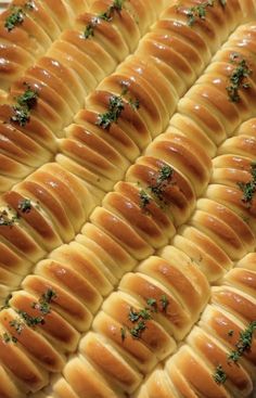 an image of bread with green toppings on the top and bottom half ready to be baked