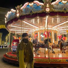 a man standing in front of a merry go round