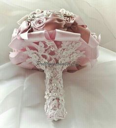 a bridal bouquet with pink roses and lace