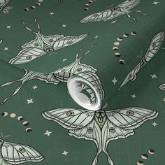 a green wallpaper with moths and stars on the background, in an artistic manner