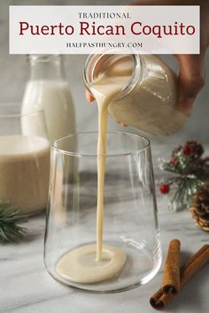 someone pouring milk into a glass with cinnamon sticks