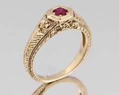 Featuring one vintage 14k yellow gold with Lab Created ruby Ring. Mounting is 14k solid yellow gold in highly polished. The lab created Red Ruby is 0.27 carat with Flawless (FL) quality. This ring features nature-inspired designs. The pattern is depicting four long leaves extending out from the center group of flowers. The Ring is heavy but very comfortable to wear. Mounting weighs 3.63 Grams Metal type: Solid 14k yellow Gold Setting : Pave setting Weight(Approx AVG) :3.63 Grams Finish: Highly p Heirloom Yellow Gold Ruby Signet Ring, Heirloom Ruby Signet Ring In Yellow Gold, Gold Ruby Signet Ring For Formal Occasions, Classic Gold Ruby Signet Ring, Yellow Gold Ruby Signet Ring For Anniversary, Fine Jewelry Yellow Gold Ruby Ring With Intricate Design, Formal Ruby Ring With Diamond Cut In Yellow Gold, 14k Yellow Gold Ruby Ring With Intricate Design, Yellow Gold Ruby Ring With Intricate Design For Promise