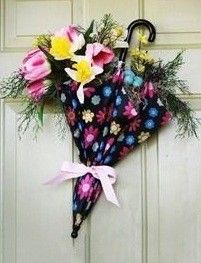 an umbrella decorated with flowers hangs on the front door