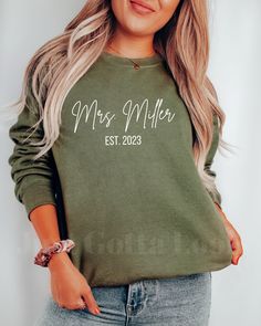 Custom Personalized Mrs Crewneck Sweatshirt HOW TO ORDER 1- Select the size of sweatshirt you would like from our dropdown menu. If you would like a larger fit make sure to size up 2- Pick the color of sweatshirt you would like from the second dropdown menu SWEATSHIRT DETAILS Ideal for any situation, a unisex heavy blend crewneck sweatshirt is pure comfort. These garments are made from polyester and cotton. This combination helps designs come out looking fresh and beautiful. The collar is ribbed Green Long Sleeve Tops With Name Print, Mrs Crewneck, Name Sweatshirt, Mrs Sweatshirt, Sweatshirt Details, Future Mrs, Bride To Be, Engagement Gifts, Sew-in Labels