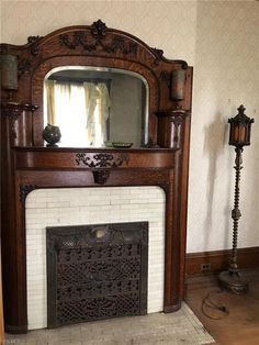 a fireplace with a mirror on top of it