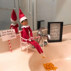 an elf is sitting in the bathroom sink