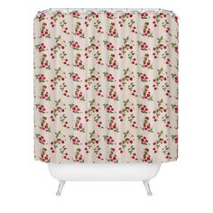 a shower curtain with red and green berries on it, in front of a white background