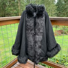 This A Brand New Cape With No Tags On It. Purchase Price- $215.00. It Is A Deep Black Color--The Sun Lightened The Color In Pictures. Made Of 48% Wool, 42% Polyester And 10% Other Fibers. Lining Is 100% Polyester. Faux Fur Is 80% Acrylic And 20% Polyester. A Stylish Silhouette With Faux Fur To Instantly Elevate Your Cold-Weather Style. Button And Loop Closure. This Cape Is Fully Lined With Faux Fur Trim Around Edges. 3 Buttons Down Front With A Loop At Top. The Arms Have A Button Closure So You Black Outerwear With Faux Fur Trim For Cold Weather, Elegant Black Outerwear With Faux Fur Lining, Fall Cape Fur Coat With Faux Fur Trim, Elegant Faux Fur Cape Outerwear, Black Cape Outerwear For Fall, Elegant Faux Fur Cape For Fall, Fall Faux Fur Cape, Cape Outerwear With Faux Fur Trim For Cold Weather, Fall Cape Outerwear With Faux Fur Lining