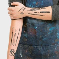 a woman with tattoos on her arm and arms