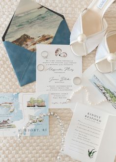 the wedding stationery is laid out on top of the bed with shoes and other items