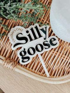 there is a sign that says silly goose on the side of a wicker basket