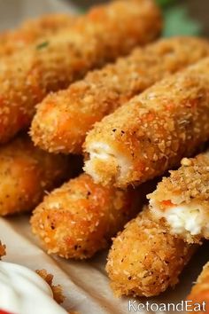 some fried food is on a plate with sour cream and ranch dressing in the background