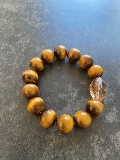 Bead size: 14mm Top bead is Rutilated Quartz. Rest is nature Tiger'eye stone. Bracelet Bead, Tiger Eye Bracelet, Tiger Eye Stone, Eye Bracelet, Eye Stone, Rutilated Quartz, Golden Brown, Stone Bracelet, Tiger Eye