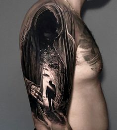 a man's half - sleeved tattoo with a black and white image of a person walking down a path