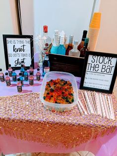 a table topped with lots of different types of condiments and bottles on top of it