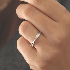 a woman's hand with a silver ring on it