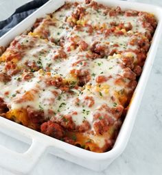 a casserole dish filled with meat and cheese