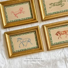 four framed pictures with horses on them sitting on a table top next to each other