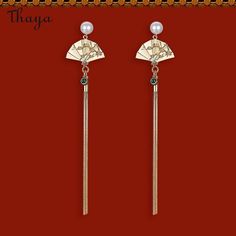 Inspired by traditional Chinese culture, these Silver Fan Tassel Earrings represent the symbol of good luck and prosperity. The intricate design and delicate tassels that sway with every movement, make a stunning statement piece for any occasion. Elevate your outfit with a touch of elegance and tradition.   - Brand: Thaya  - Material: alloy  - Style: Fan  - Gender: Women Asian Inspired Earrings, Chinese Earrings Traditional, Hanfu Earrings, Traditional Chinese Jewelry, Japan Earrings, Chinese Earrings, Japan Jewelry, Chinese Jewelry, Asian Jewelry