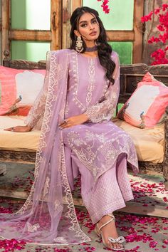 Luxury Lilac Organza Pakistani Salwar Kameez Dupatta Salwar Suit embodies the concept of beauty with a subtle touch. The organza shirt is decorated with white thread embroidery with motif details. The front is adorned with silver sequin and adda work embellishments to enhance the look. The outfit comes with Pakistani raw silk culottes topped with a net embroidered dupatta. Organza Kameez: The kameez in organza fabric is emblazoned with lavish floral designs and embroidery. Beaming sequins and th Elegant Purple Kurta With Sheer Dupatta, Elegant Purple Sharara With Chikankari Embroidery, Formal Purple Sets With Chikankari Embroidery, Purple Embroidered Lawn Suit For Wedding, Purple Organza Sharara For Eid, Elegant Purple Organza Salwar Kameez, Purple Lawn Suit With Dupatta For Formal Occasions, Formal Purple Lawn Suit With Dupatta, Elegant Purple Salwar Kameez With Chikankari Embroidery