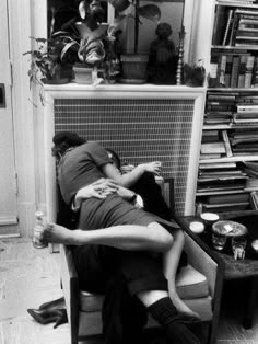 black and white photograph of two people sleeping on a couch