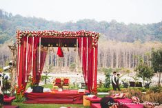 an outdoor ceremony with red and gold decor