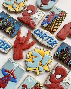 decorated cookies are arranged in the shape of superheros and spider - man's