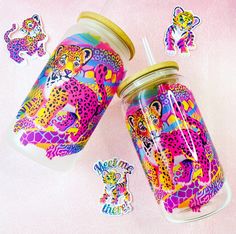 two jars with stickers on them sitting next to each other and one has a cup in it