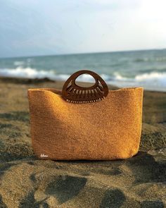 Beach Bag with Wooden Accessories, Crochet Raffia Tote Bag, Raffia Beach Bag, Summer Shopper Bag, Woven Shoulder Bag, Straw Beach Tote Bag, Handmade Gift Any woman must have this bag for every fashionista. Whether you keeping it to yourself or gifting someone you care, it will be unforgettable. I made this beautiful bag from caramel natural paper rope which is organic cotton and wooden accessories. The interior of the straw summer bag is fully lined with cotton and has a magnetic button. Suitabl Raffia Beach Bag, Straw Beach Tote, Raffia Tote Bag, Handmade Crochet Bags, Summer Tote Bags, Crochet Weaves, Beach Tote Bag, Wooden Accessories, Summer Tote