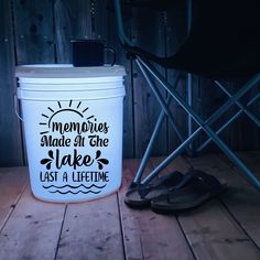 a white bucket sitting on top of a wooden floor